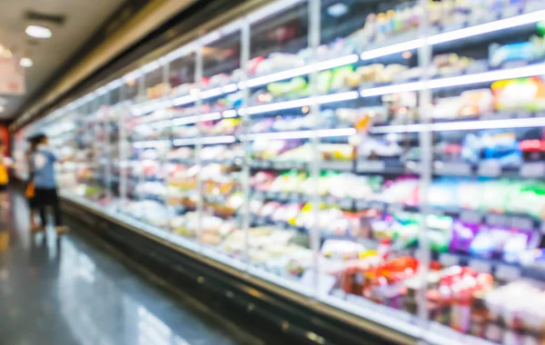 Blurred supermarket aisle shelves chilled products zone