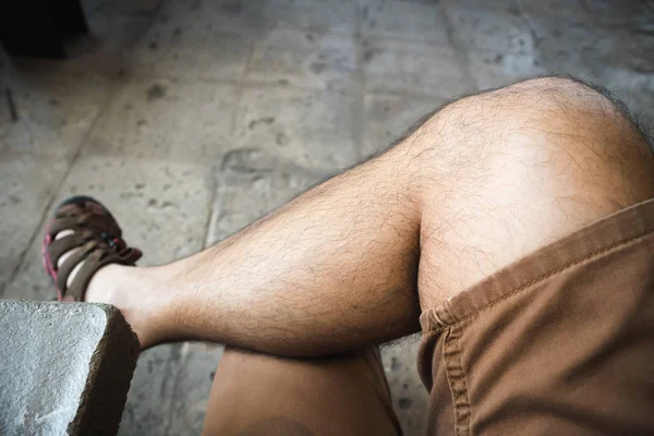 Man in brown shorts chill sitting cross-legged