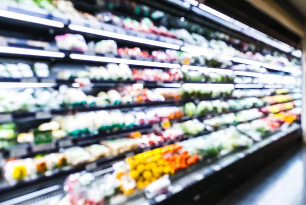 Blurred supermarket aisle shelves chilled fruit and vegetable zone