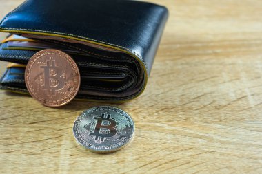 Bitcoin dijital para yerine gerçek para, bit-sikke ile deri cüzdan veya çantanızda ahşap çalışma masa, sanal cryptocurrency para iş kavramı fikri üzerinde.