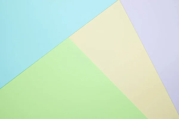 Fashionable  pastel colored paper flat lay top view, geometric background texture, pink, purple, yellow, beige, green and blue colour.