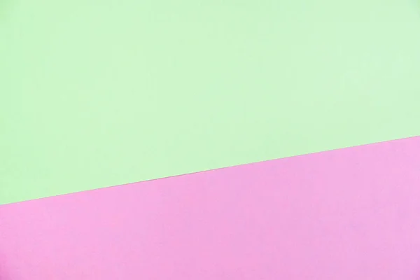 Pastel colored paper flat lay top view, background texture, green and pink colour.