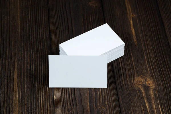 Blank business cards on wooden working table with copy space for add text ID. and logo, business company concept idea.