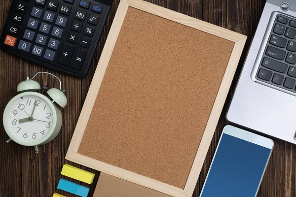 Office supplies or office work essential tools or items on wooden desk in workplace, top view with copy space for add text and message.