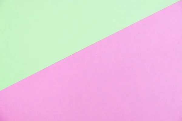 Pastel colored paper flat lay top view, background texture, green and pink colour.