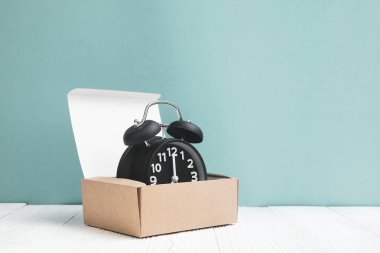 Kahverengi teslim karton kutu veya beyaz tahta ve mavi duvar arka plan, zaman ve son tarih kavramı fikir tepsiye Retro çalar saat.