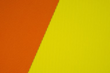 Sarı ve turuncu oluklu kağıt dokusu, arka plan için kullanın. kopya alanı için canlı renkli metin veya nesne eklemek.