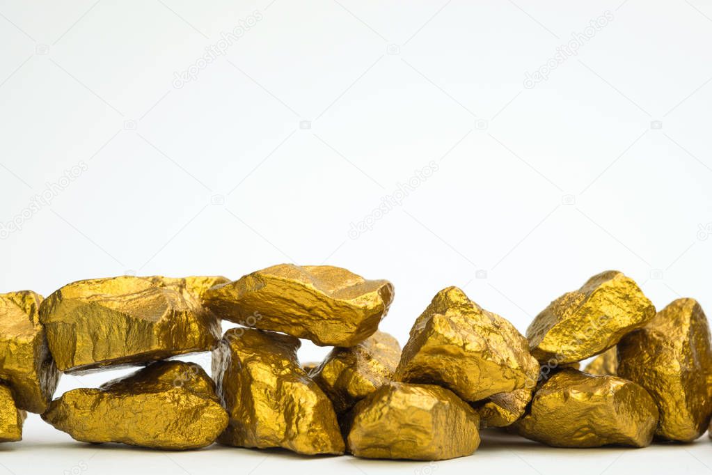 A pile of gold nuggets or gold ore isolated on white background, precious stone or lump of golden stone, financial and business concept idea.