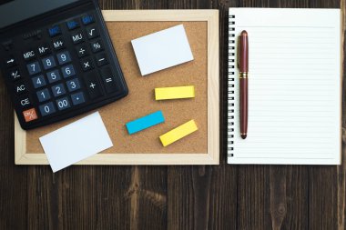 Ofis, banka donatımı veya office çalışma temel araçları veya öğeleri çalışma alanı'ndaki ahşap masa üzerinde kopyalama yeri olan üstten görünüm eklemek metin ve mesaj.