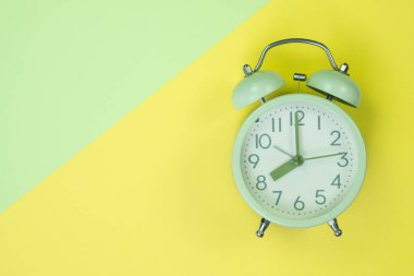 Tatlı pastel renkli kağıda üstten görünüm, arka plan dokusu, pembe, mor, sarı, bej, yeşil ve mavi renkli düz yatıyordu vintage çalar saat.