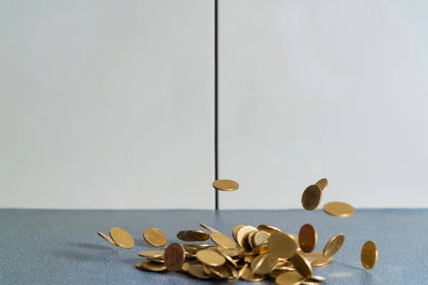 Falling gold coins money on office table with document cabinet background, business money and finance concept idea.