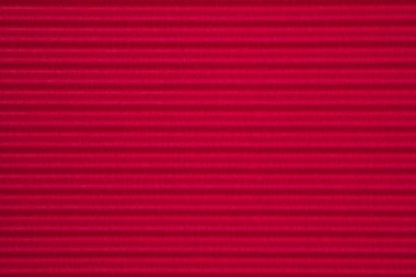 Kırmızı oluklu kağıt dokusu, arka plan için kullanın. kopya alanı için canlı renkli metin veya nesne eklemek.