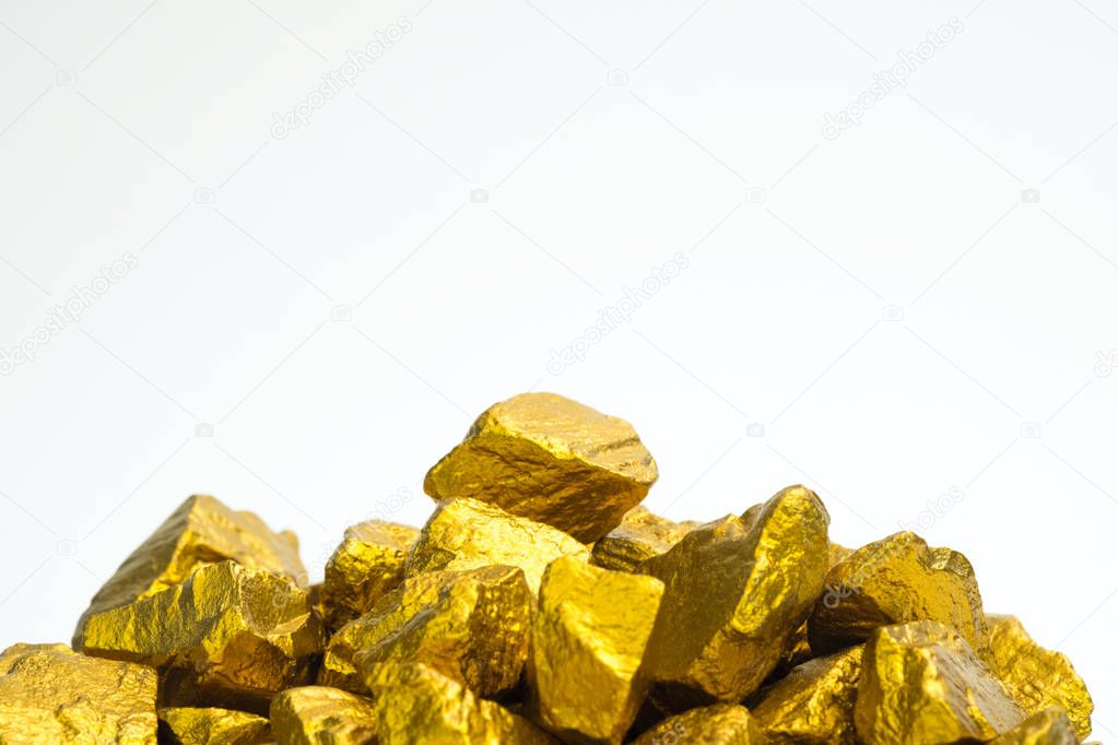 A pile of gold nuggets or gold ore on white background, precious stone or lump of golden stone, financial and business concept idea.