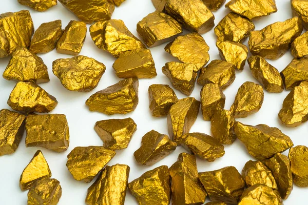 A pile of gold nuggets or gold ore on white background, precious stone or lump of golden stone, financial and business concept idea.