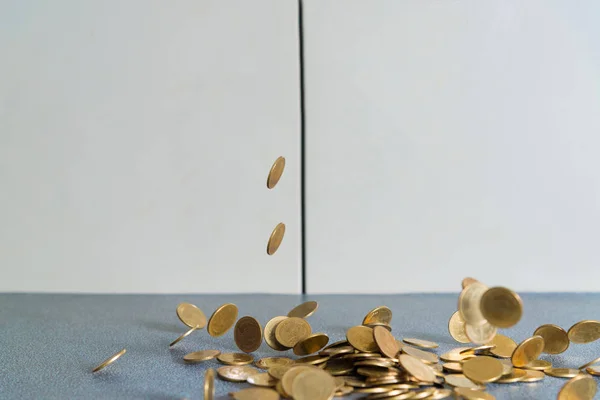 Falling gold coins money on office table with document cabinet b