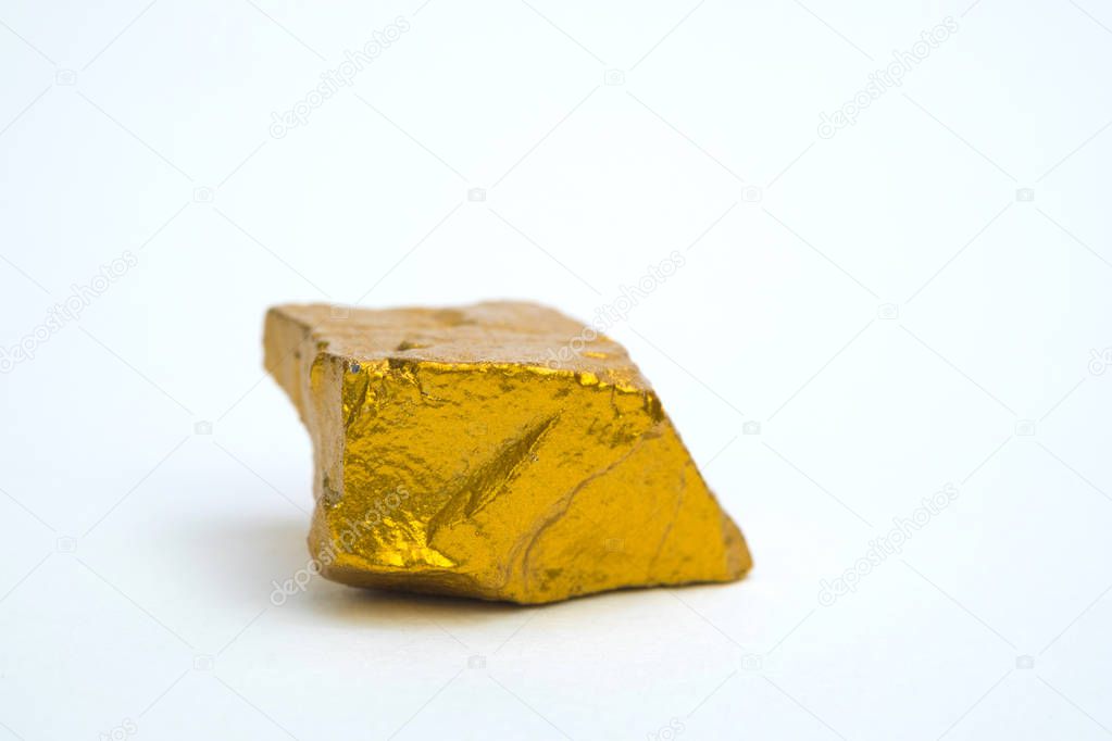 Closeup of gold nugget or gold ore on white background, precious