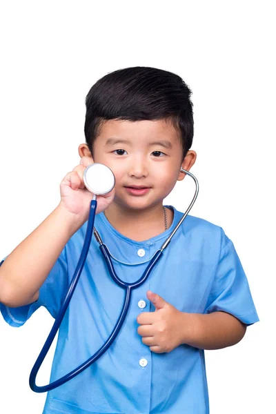 Smiling Asian kid in blue medical uniform holding stethoscope is — Stock Photo, Image