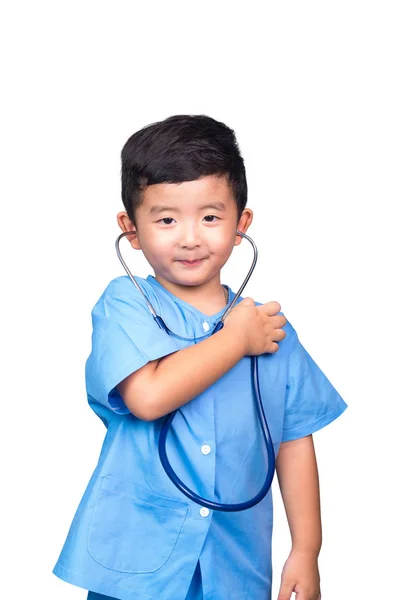 Smiling Asian kid in blue medical uniform holding stethoscope is — Stock Photo, Image