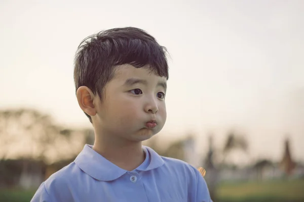Outdoor portrait of a happy Asian student kid in school uniform — Stock Photo, Image