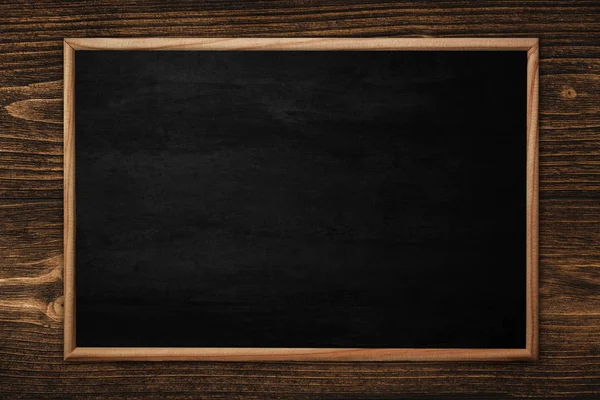 Abstract blackboard or chalkboard with frame on wooden backgroun — Stock Photo, Image