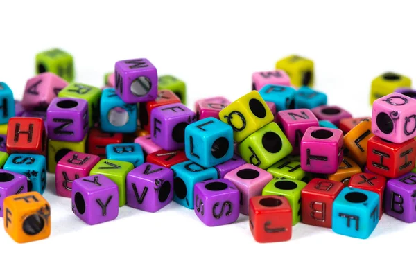 Pile of letter bead or beads with alphabet on white background. — Stock Photo, Image