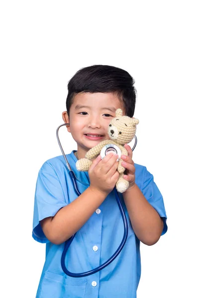 Smiling Asian kid in blue medical uniform holding stethoscope is — Stock Photo, Image