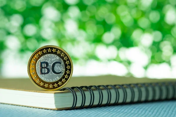 Bitcoin digital currency,  bit-coin on green blurred bokeh backg