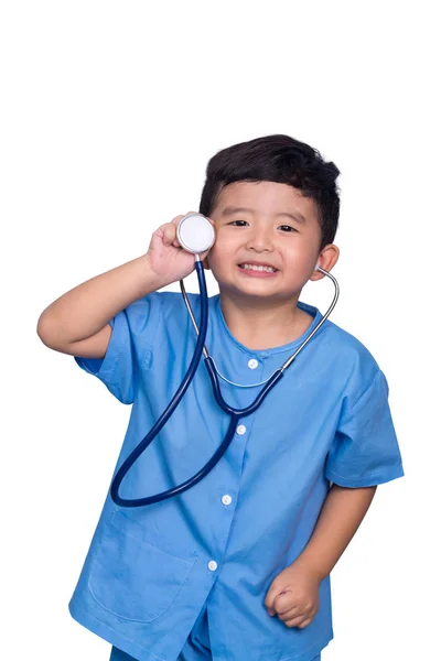 Smiling Asian kid in blue medical uniform holding stethoscope is — Stock Photo, Image