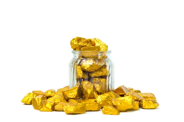 Gold nuggets or gold ore and glass jar isolated on white backgro