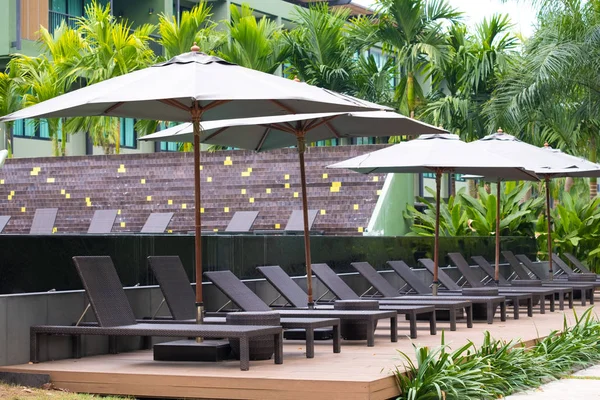 Silla de cubierta o baño de sol cerca de piscina privada con sol umbrel — Foto de Stock