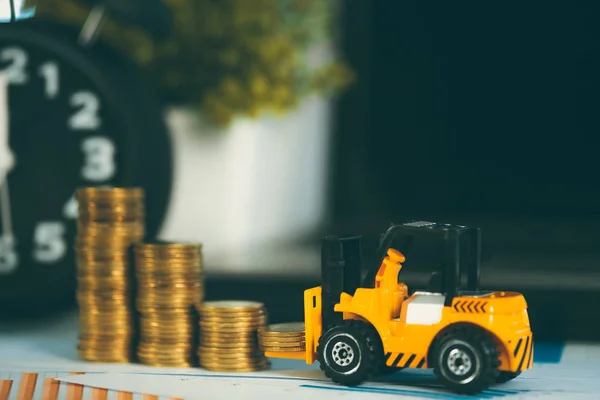 Miniature mini forklift truck with coin stack on working table w — Stock Photo, Image