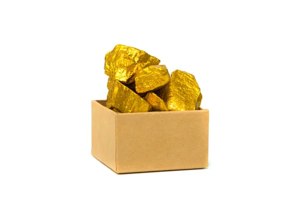 Gold nuggets or gold ore and cardboard box isolated on white bac