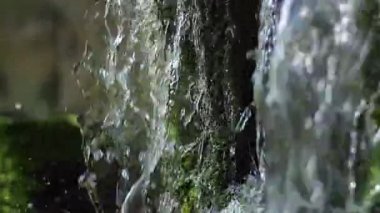 kadar yakın şelale sıçrama, kaynak suyu closeup bu düşer ve yeşil yosun üzerinde koşuyor gibi yakın vuruşta büyük güzel şelale yakın çekim su damlası