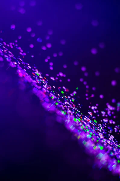 Colorful lights blurred glitter background. Abstract illuminated texture. Christmas, new year or birthday celebration. Night life photography — Stock Photo, Image