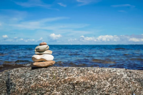 Small stone tower by the sea as a symbol of Buddhism and inner balance at the beach of Baltic Sea