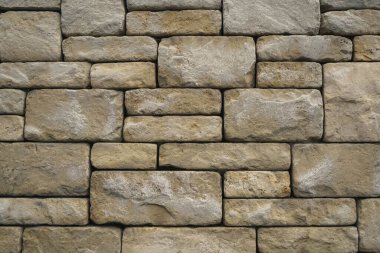 Bahçe için sarı ve kırmızı kum taşlarından yapılmış duvar ve arka plan dokusu olarak