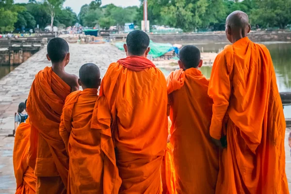 Young monks in orange robes in Angkor Wat Temple, Siem Reap, Cambodia.