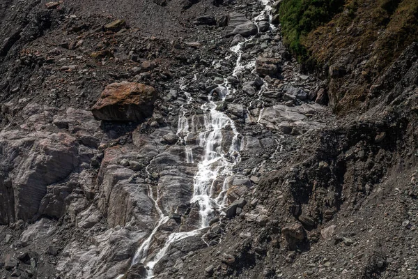 Waterfall at Fox Glacier Valley Walk, New Zealand.