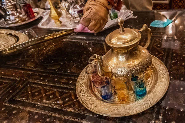 Moroccan handmade metal lamps and plates at the shop in Medina of Fez, Morocco.