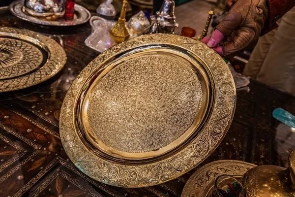 Moroccan handmade metal lamps and plates at the shop in Medina of Fez, Morocco.