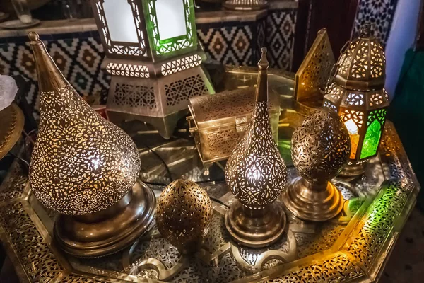 Moroccan handmade metal lamps and plates at the shop in Medina of Fez, Morocco.