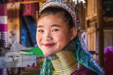 Long-necked Karen woman wearing tribal jewelry and brass rings on the neck. Chiang Rai, Thailand - November 15 2017. clipart