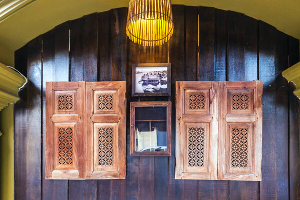 Wooden shutters on the windows in different shapes. Colorful buildings in old Phuket town in Thailand. Sino Portuguese style. Phuket, Thailand - October 25 2017.