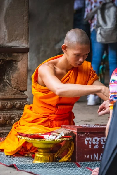Turuncu cüppeli keşiş Angkor Wat Tapınağında dua ediyor. Siem Reap, Kamboçya - 19 Kasım 2017.