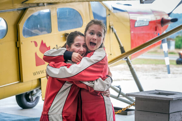 Scared girl prepares to skydive. Franz Josef Glacier, New Zealand - January 02 2018.