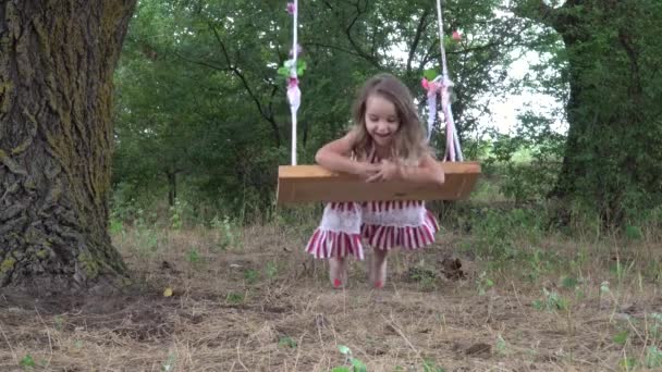 Playful Little Girl Riding Swing Close Laughing Smiling — Stock Video