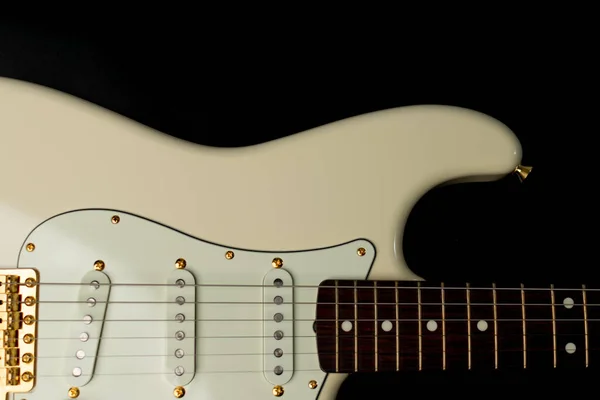 Close up of Olympic white guitar on a black background