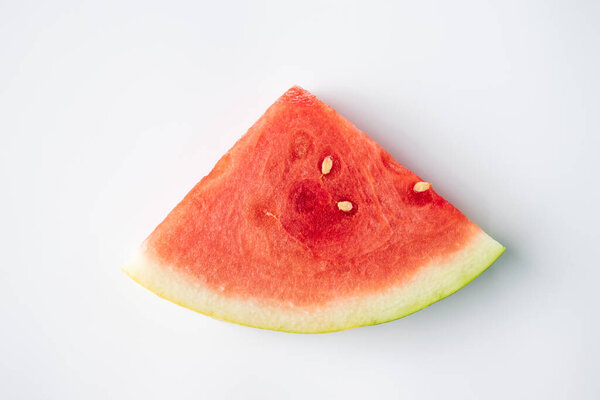 sliced watermelon fruit sitting on a white marble background