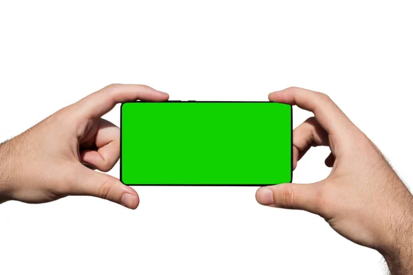 Smartphone em mãos com tela verde para espaço de cópia isolado em fundo branco — Fotografia de Stock