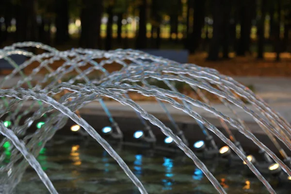 Night water fountain.Water is seen cascading in many arches in the photograph